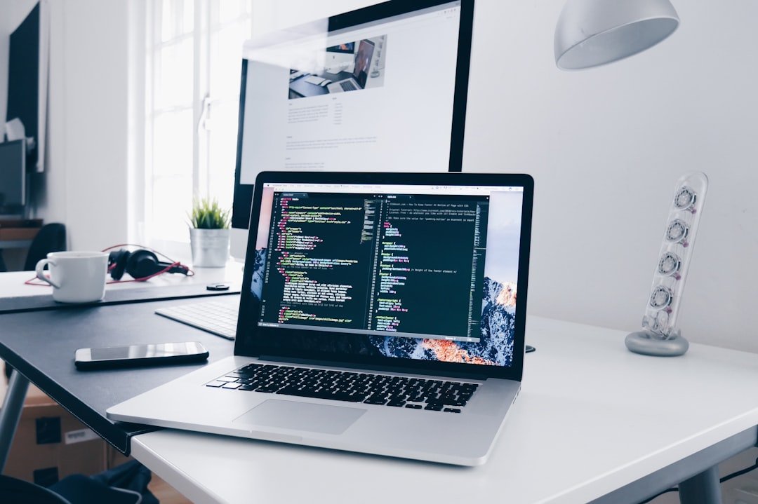 Laptop screen showing lines of code with AI-assisted suggestions